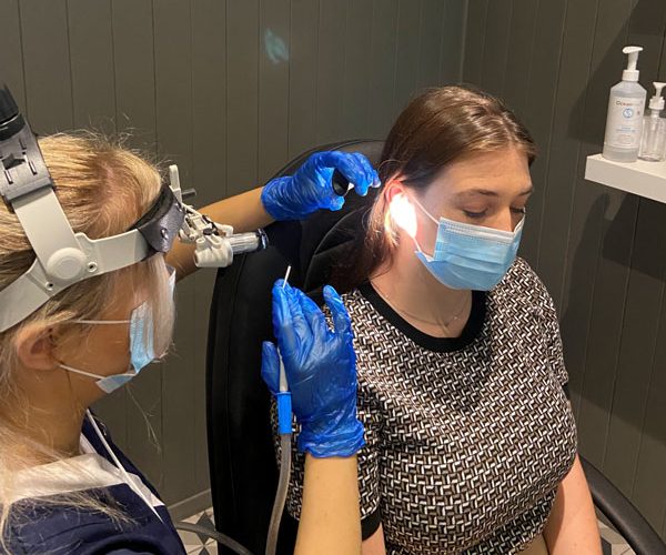 Audiologist performing microsuction earwax removal