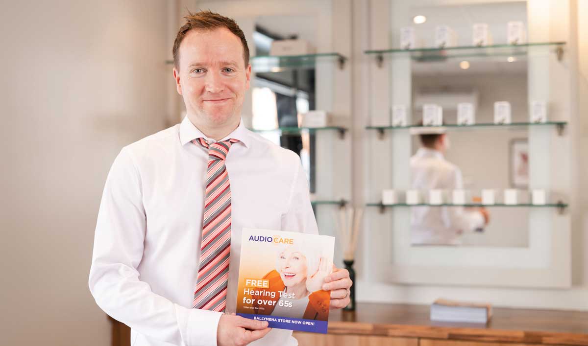 Audiocare owner and audiologist Michael at their hearing clinic storefront in Ballymena Northern Ireland